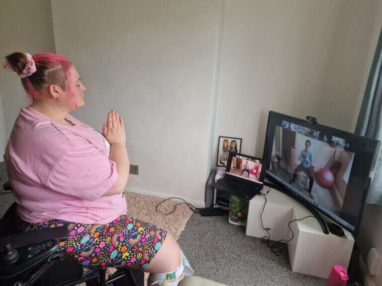 a mobilates member enjoying an online pilates class