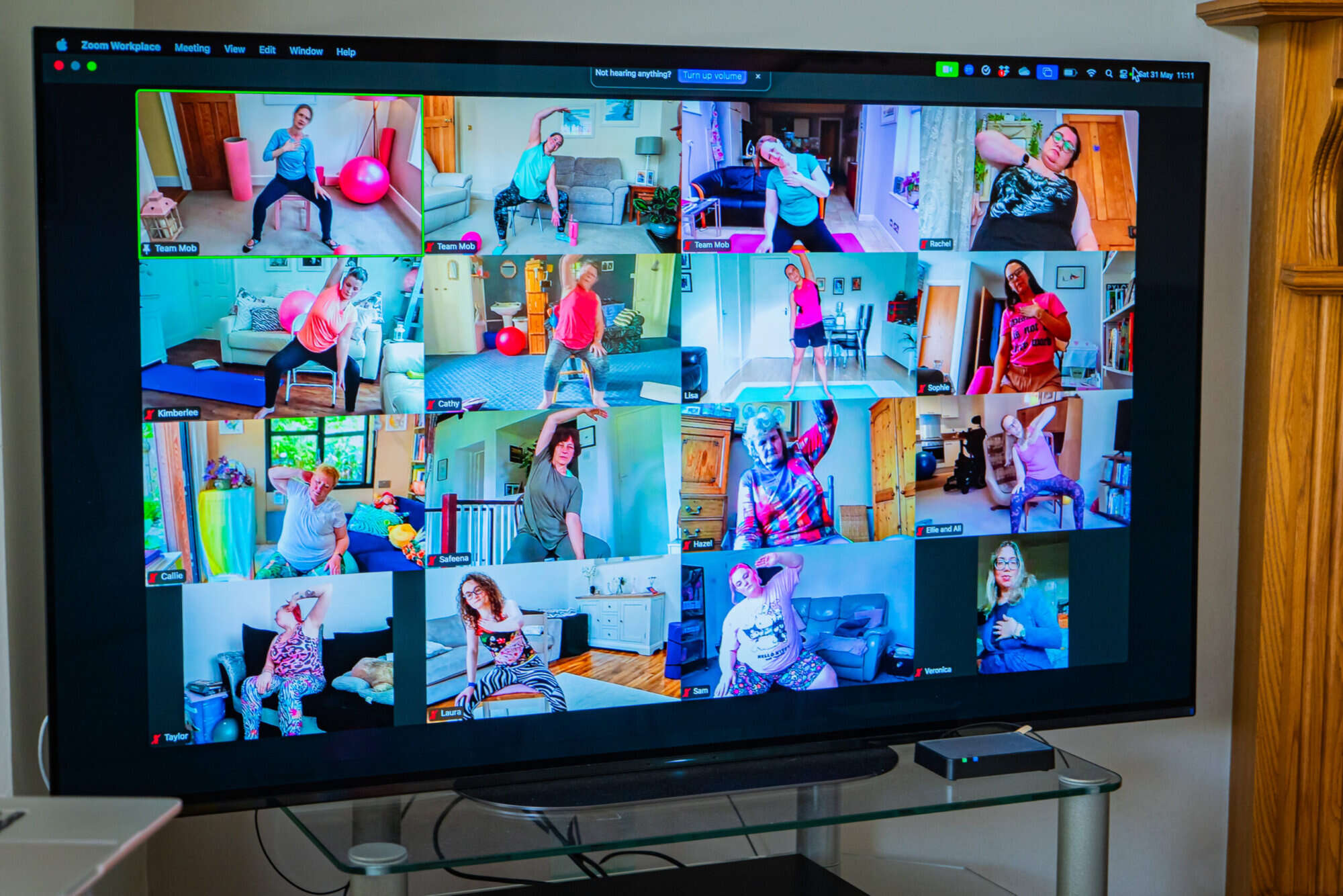 Online Mobilates class with many members visible on screen