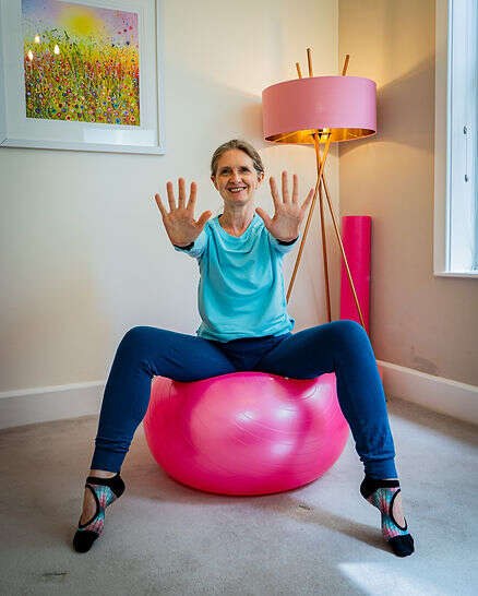 kerry sitting on a bright pink exercise ball
