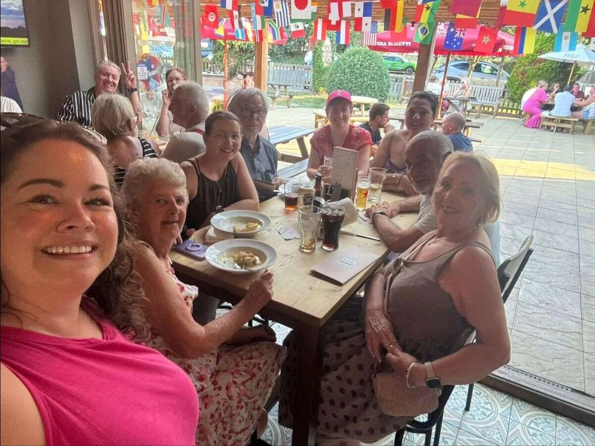 Suzanne and Mobilates members and friends celebrating together around a table at a pub