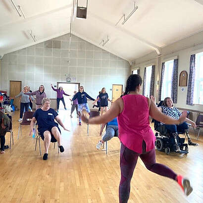 Members on the retreat having a dance, some seated, some standing